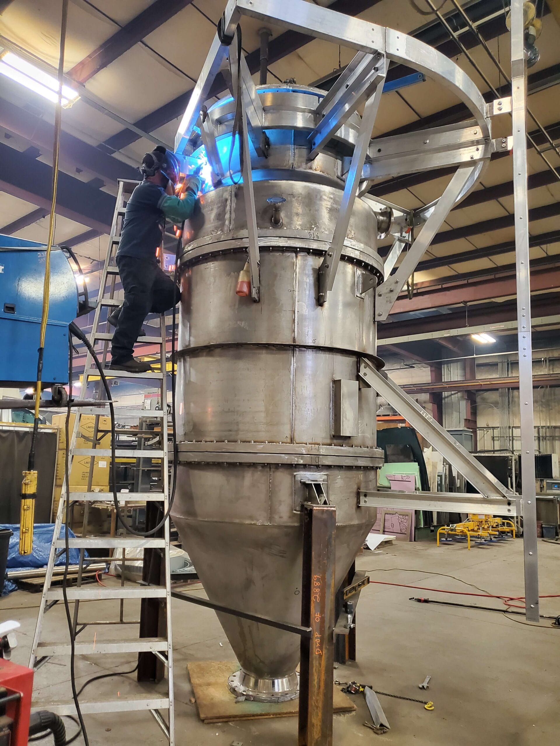 Assembling a pulse jet baghouse with explosion venting for enhanced explosion protection in a polycarbonate process.