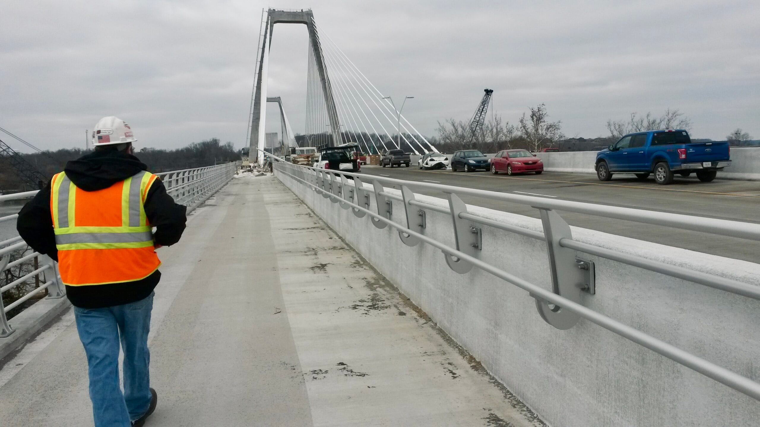Surveying-LW-bridge QC check on the safety railing installation for the lewis and clark bridge, part of the Ohio River Bridges project.