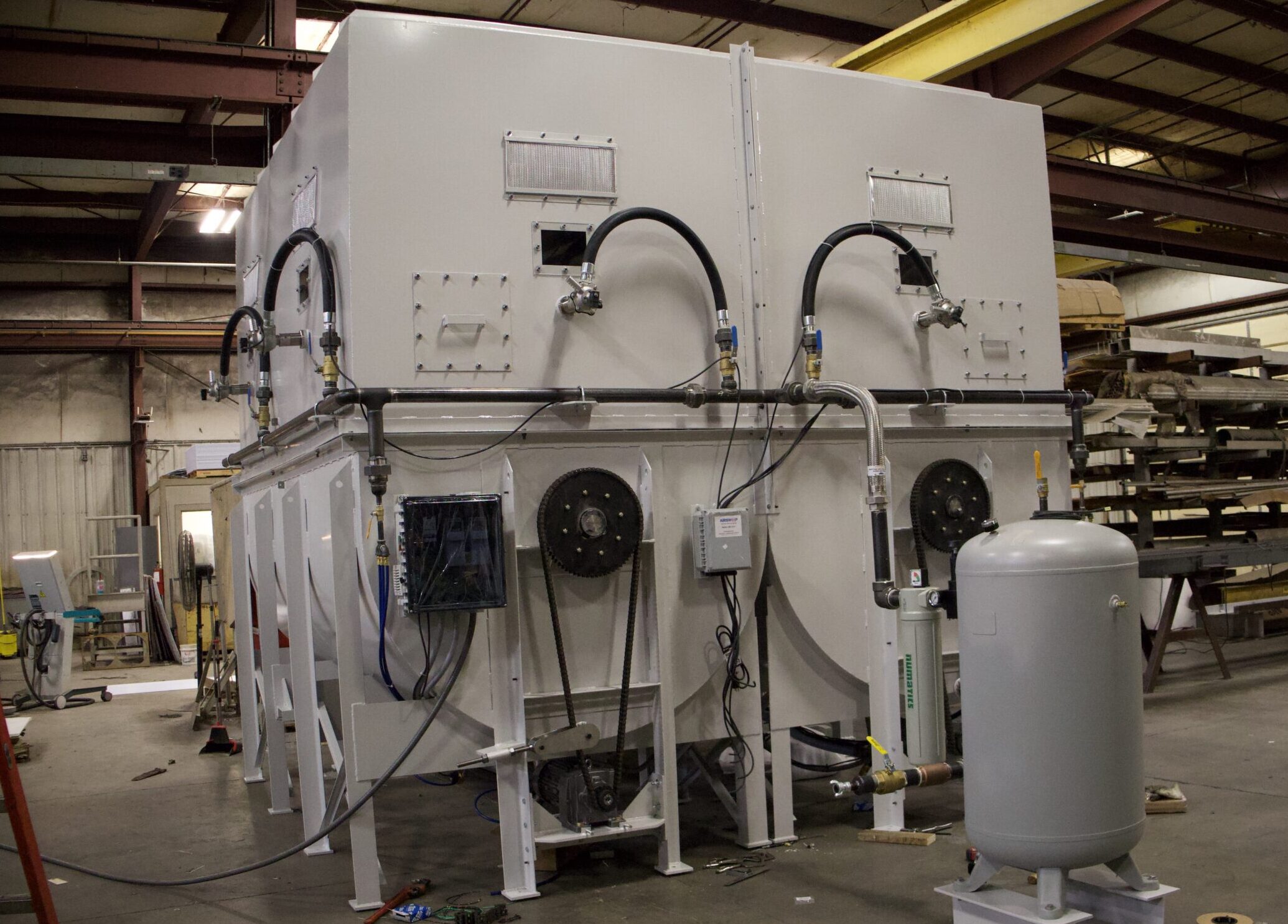 Final assembly of custom hopper and agitation system for fluff storage and handling.