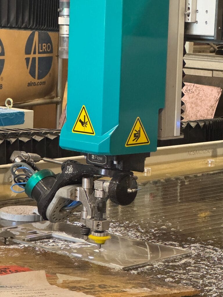 Mach waterjet table in Heumann Environmental metal shop