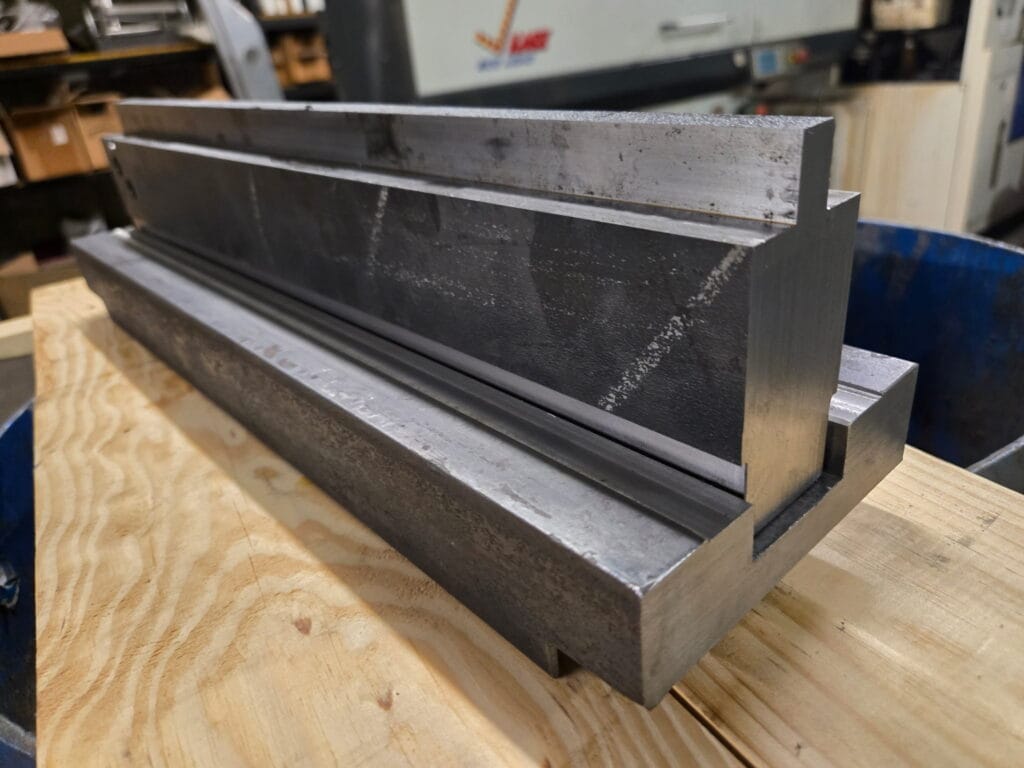 Custom metal die fabricated for press brake to produce brackets for highway construction project.