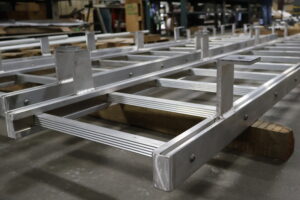 Sections of a fixed ladder assembly waiting to be packaged and shipped out of the Heumann Environmental fabrication shop.
