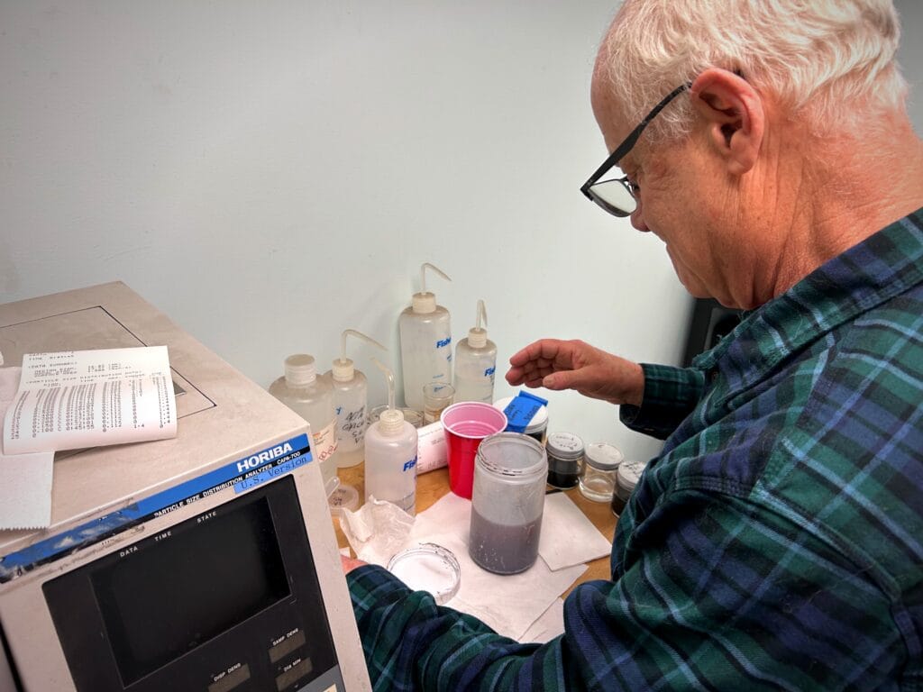 bill-preparing-sample-enhanced CEO of Heumann ENvironmental preparing a fly ash test sample for aerodynamic particle size testing