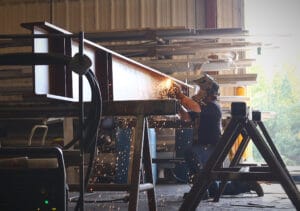 Welding a cross-beam steel lintel in the Heumann Environmental shop